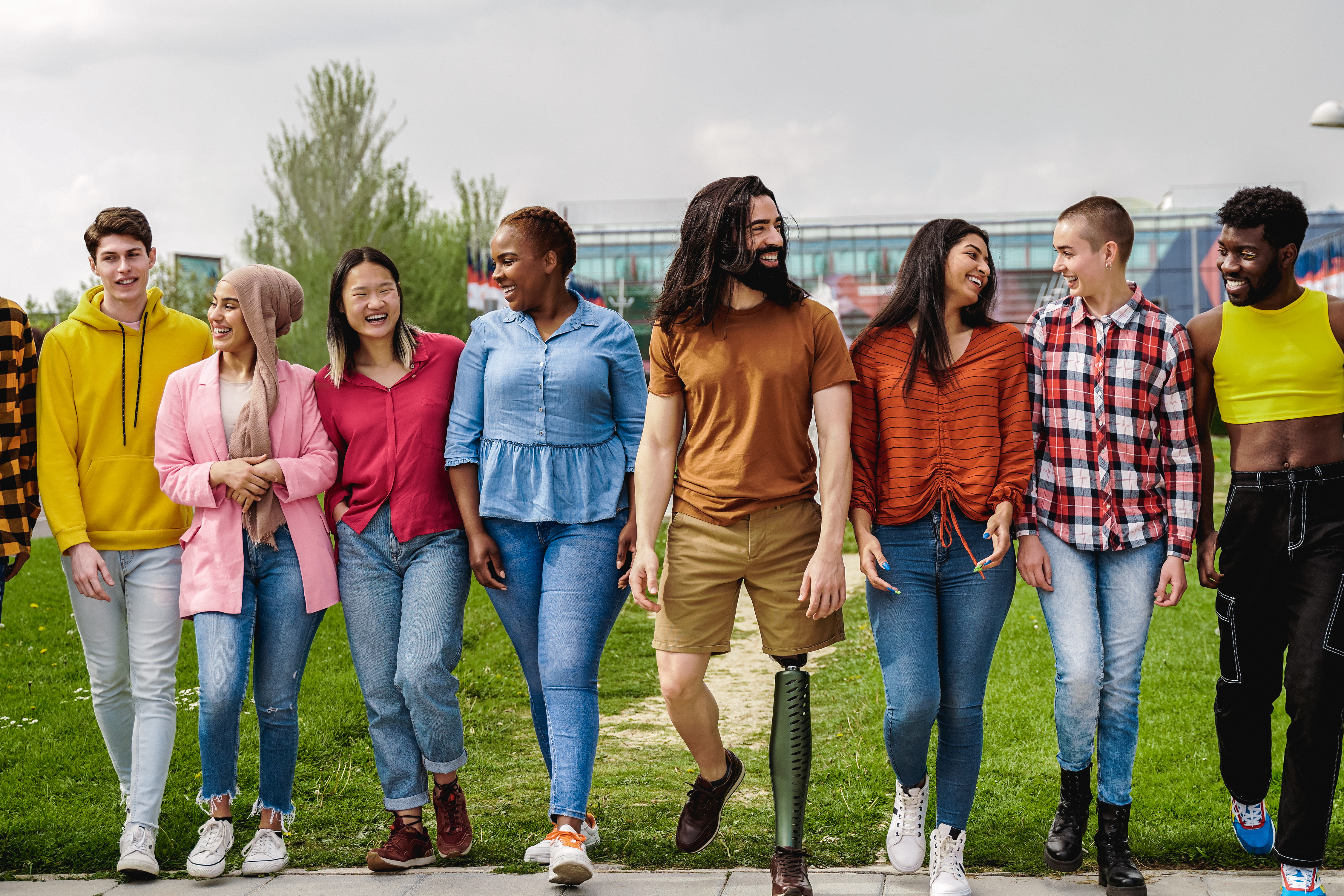 Diverse happy group of people having fun outdoor - Focus on man with prosthesis on leg